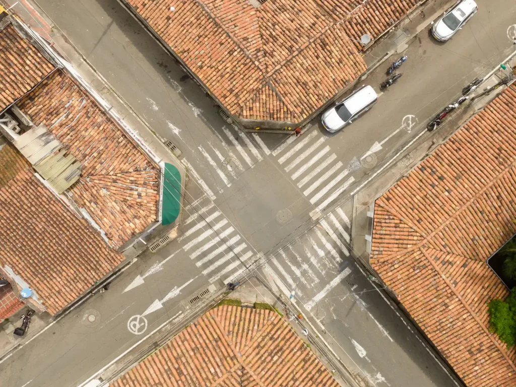 Aerial view of an intersection with terracotta rooftops, representing different paths converging — like those in gay couples therapy in Los Angeles