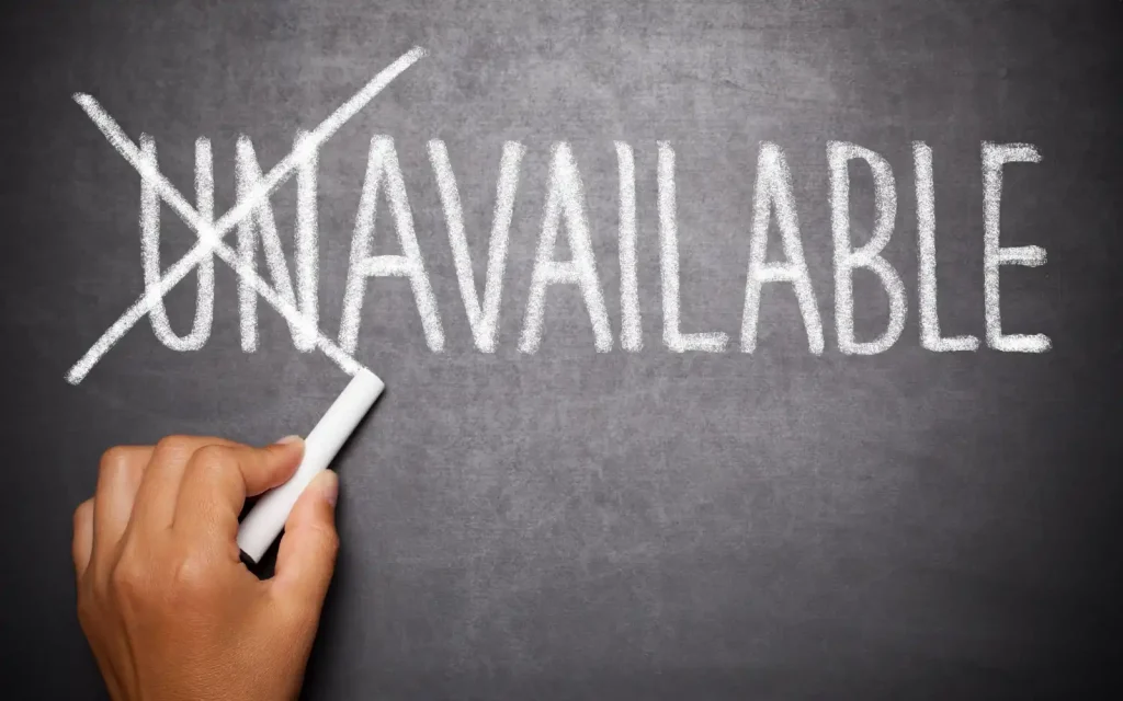 You word unavailable handwritten on a chalkboard with the prefix "Un" crossed out, representing emotional unavailability