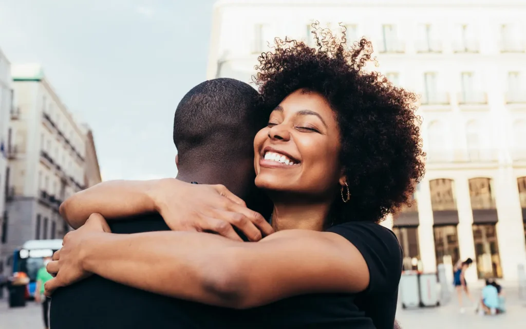 Happy-couple-relationship-therapy A black heterosexual couple embracing after successful couples therapy