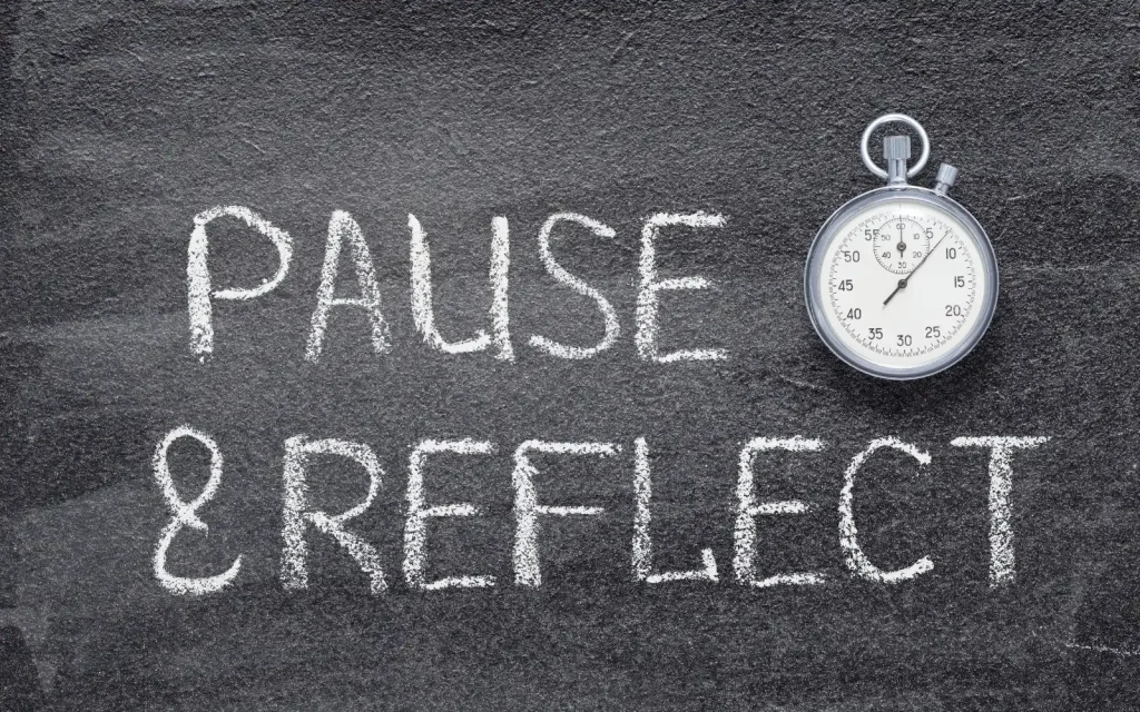 Interracial-couples-therapy-racial-biases The words "Pause and Reflect" written on a chalkboard, representing the importance of reflecting on your own racial biases