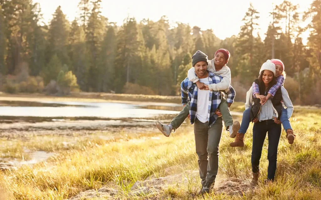 Interracial-family-on-walk An interracial family, two parents and two children, on a walk beside a riverbank.