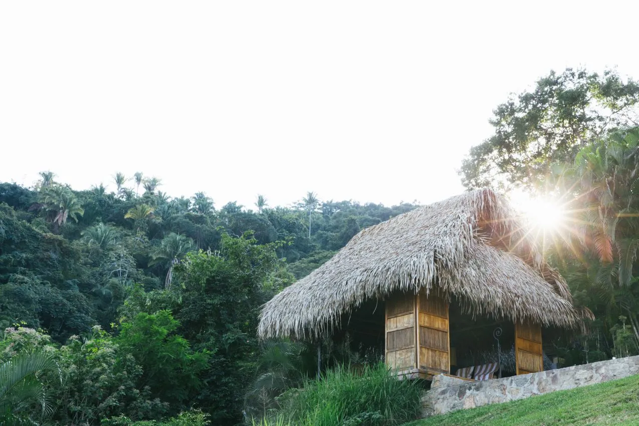 A secluded open-air bungalow at a private couples retreat in Verana, offering breathtaking ocean views and a peaceful escape for partners.