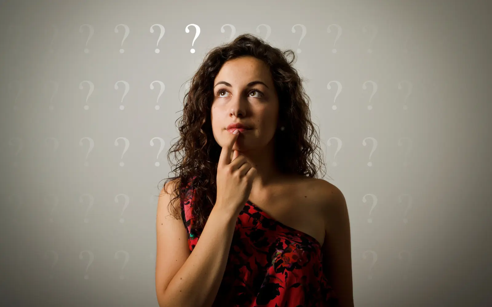 A woman looking up inquisitively, representing the question: Can too much therapy be bad?