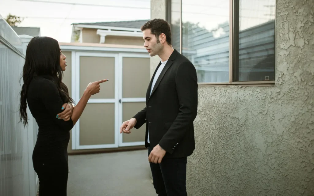 Cultural-differences-in-couples-therapy A mixed race couple arguing in an alleyway outside an office building