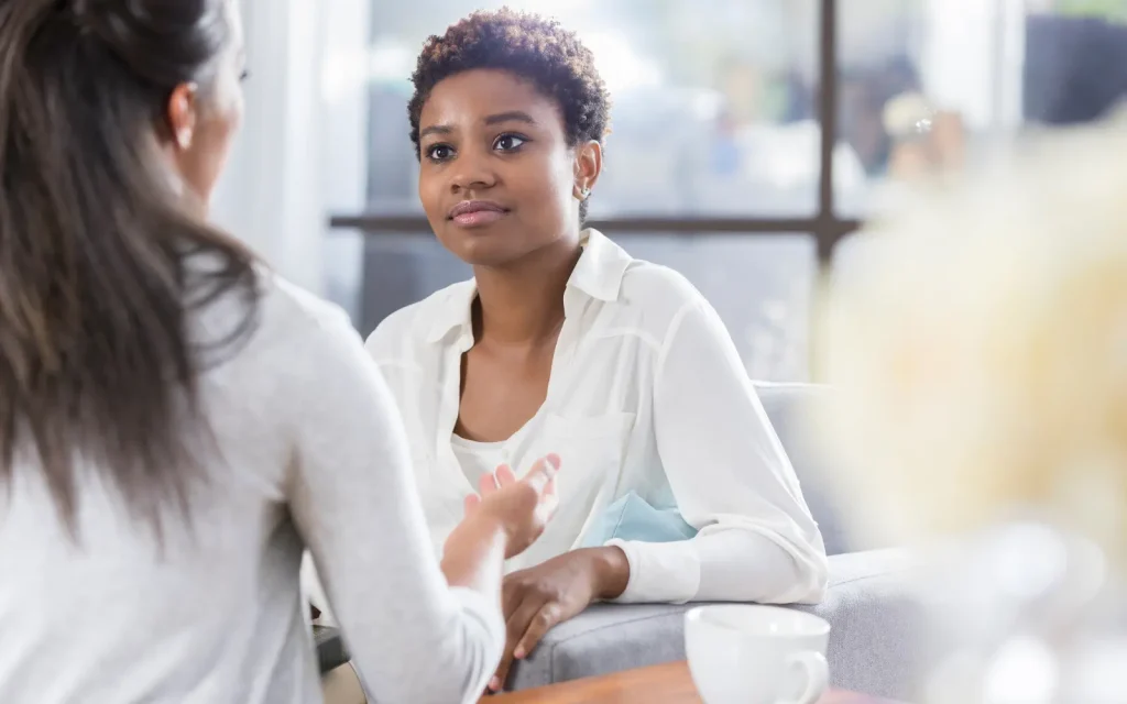 Therapist-holding-space-for-clients-internal-processing A female therapist giving their client undivided attention during a session, representing how therapists hold the space for their clients' internal processing