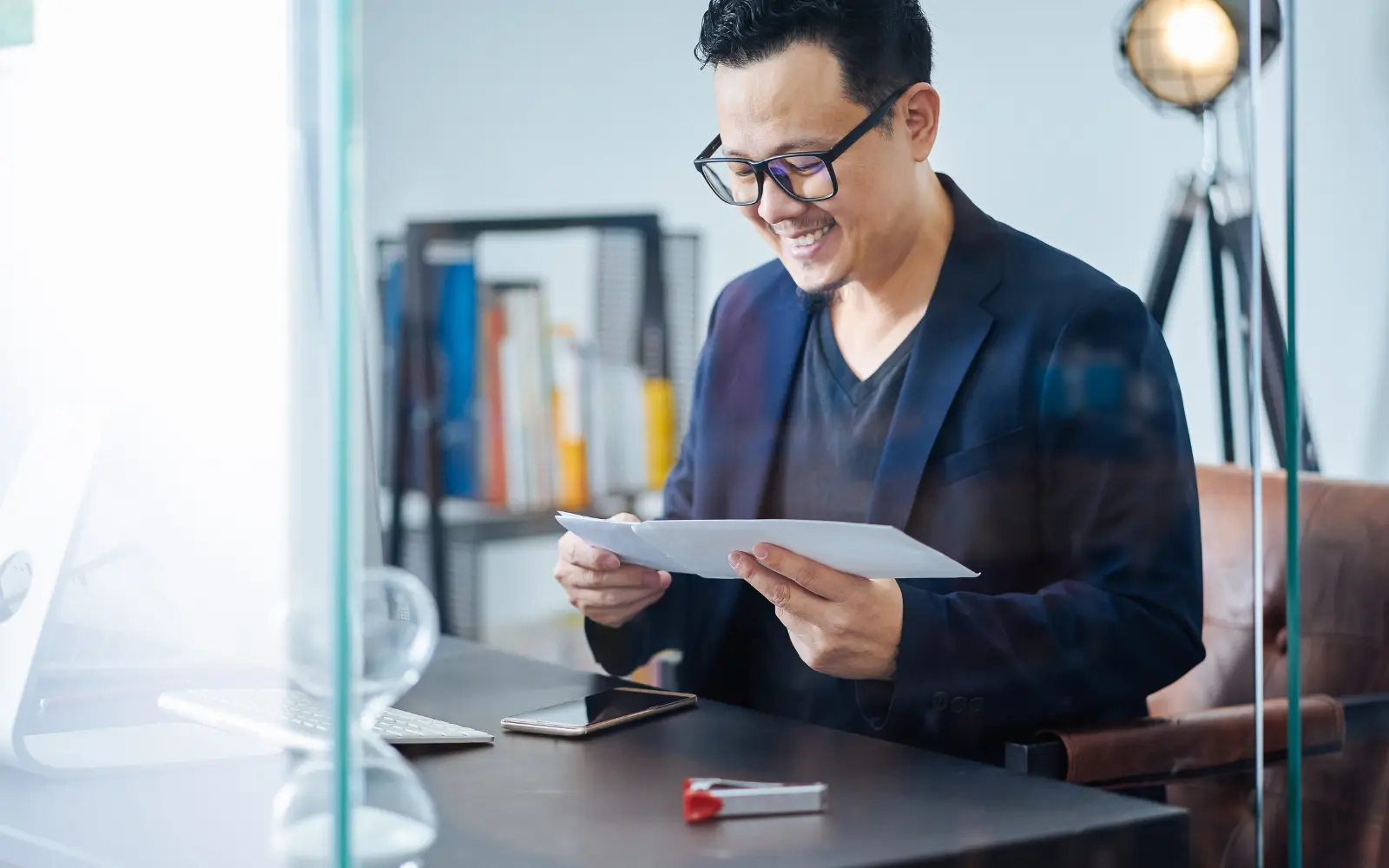 A man smiling as he opens and reads his neuropsychological testing results
