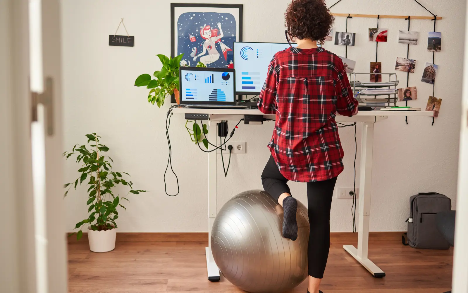 A woman kneeling on a yoga ball and working at a standing desk, representing how neuropsychological testing can unlock access to workplace adjustments to help you succeed
