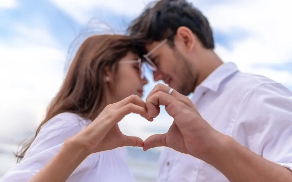 Couples-therapy-Los-Angeles-and-conflict-resolution A couple making their hands into a heart shape, representing the benefits of couples therapy in conflict resolution in LA