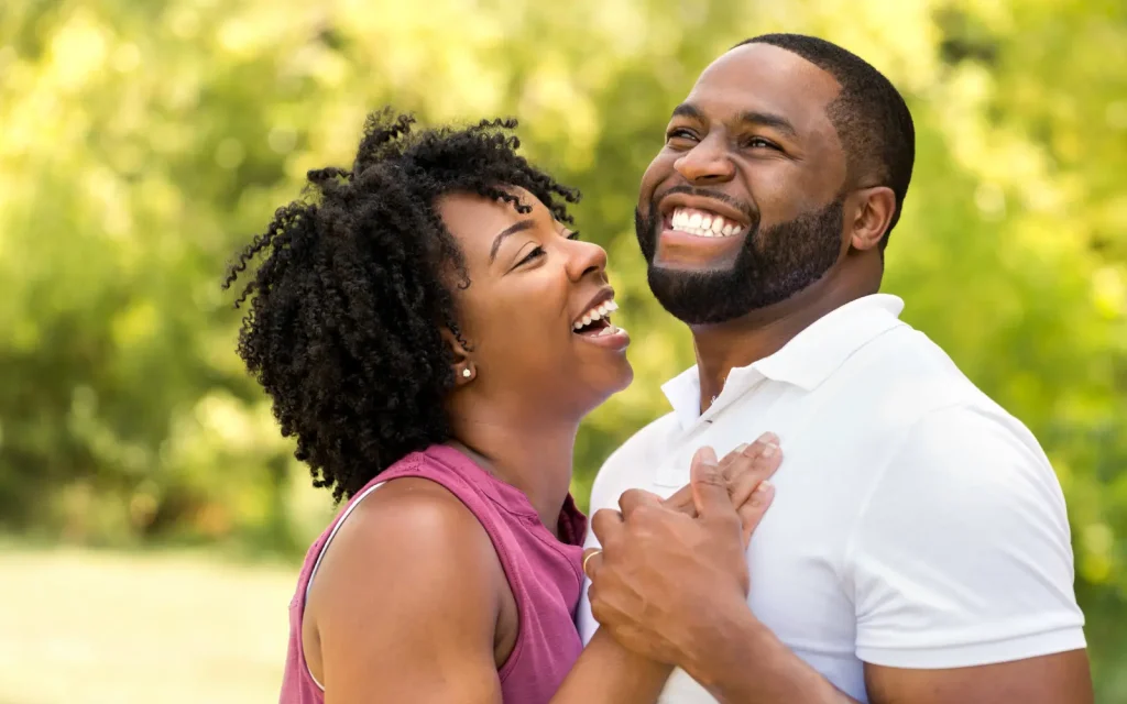 A black couple smiling and laughing, representing the positive impact of GGPA's marriage counseling in Los Angeles