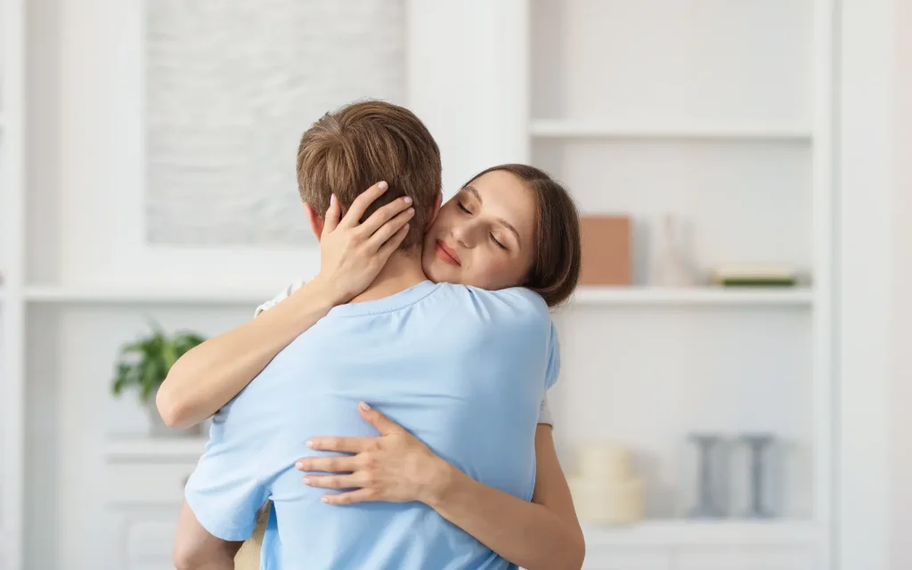 Calm-home-after-couples-therapy A woman hugging her partner close, representing the benefit of a calm home after successful couples therapy.