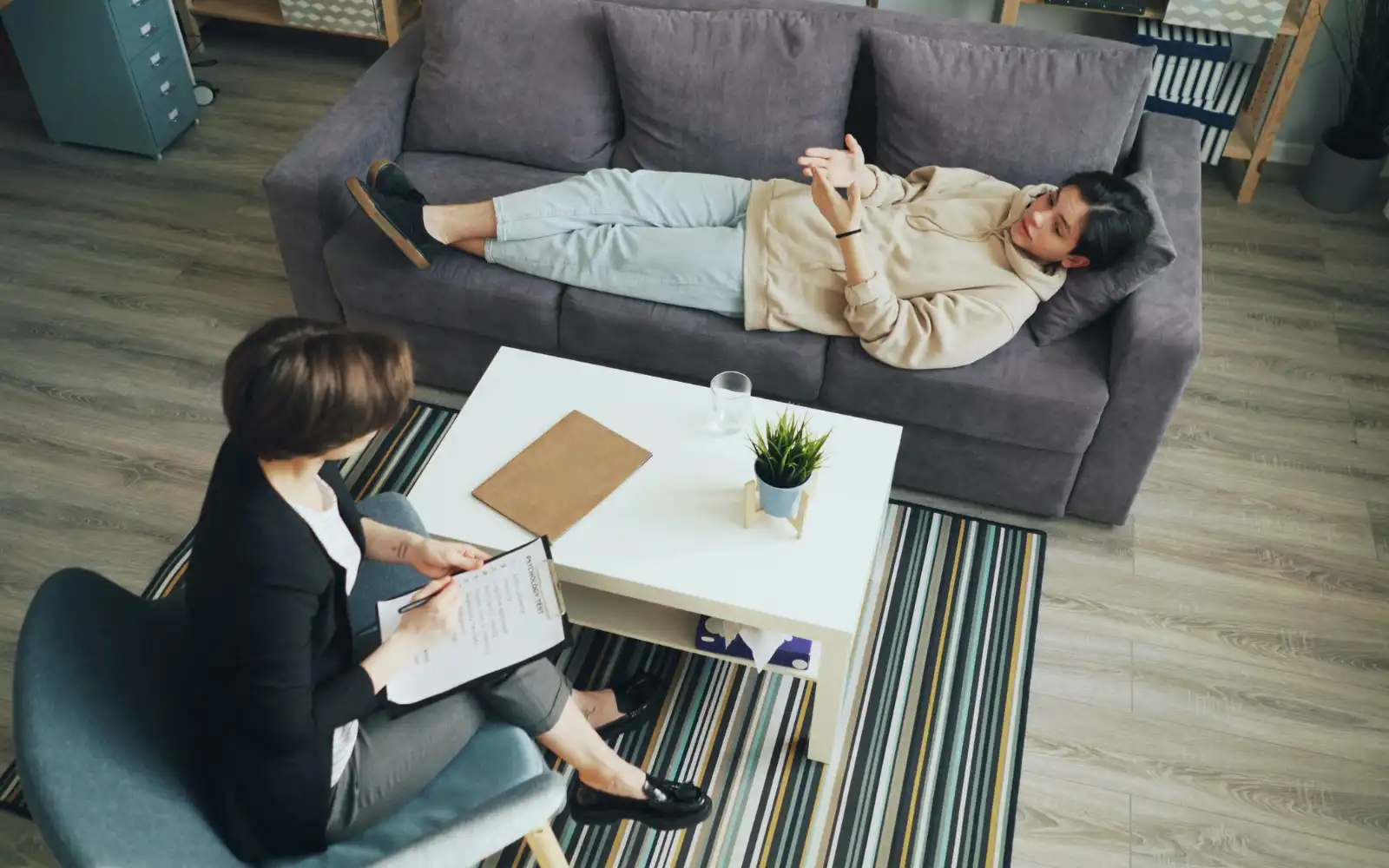 A woman lying on a sofa in a Los Angeles trauma therapy session