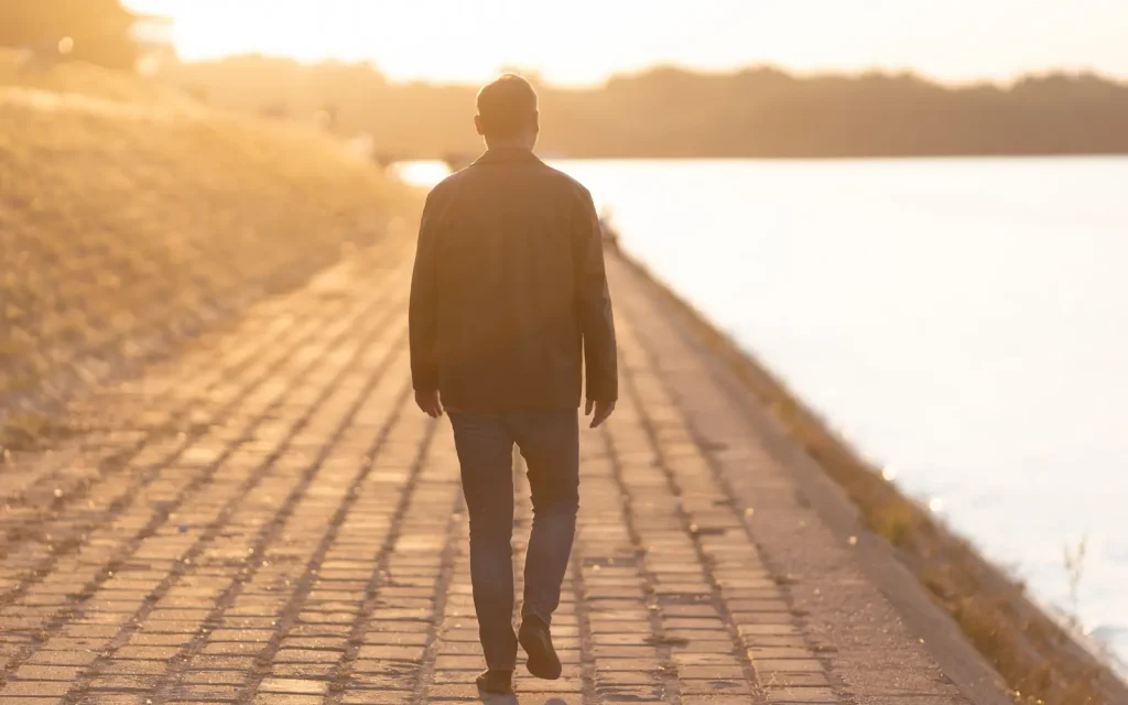 Walking-away-from-therapy-in-Los-Angeles A man walking down a path beside the Pacific alone, representing the impact of walking away from therapy in Los Angeles
