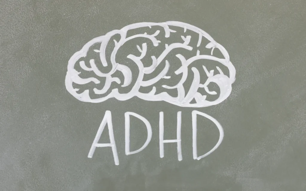 A drawing of a brain on a chalkboard with the acronym ADHD underneath, representing ADHD therapy offered by GGPA in Los Angeles