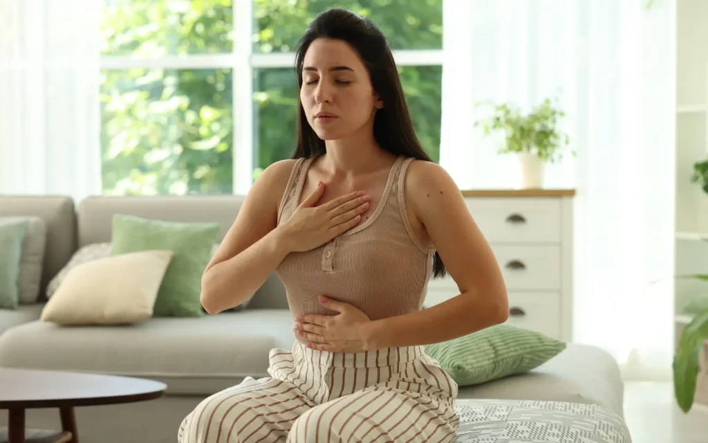 Calm-replacing-hypervigilance A woman practicing breathing techniques to replace her hypervigilance with calm