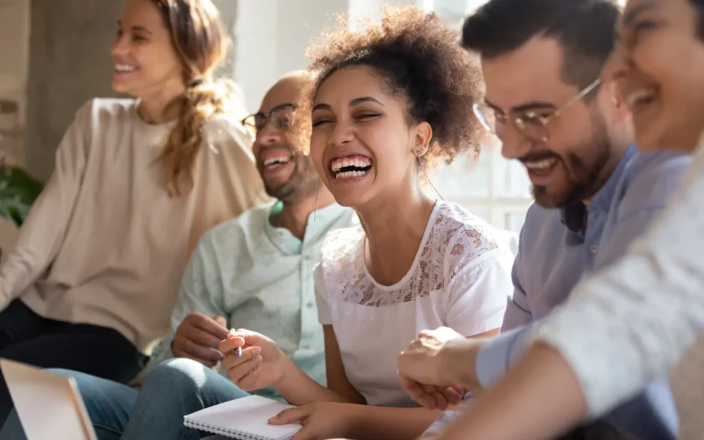 A group of laughing people, representing the emotional freedom regular therapy in Los Angeles brings