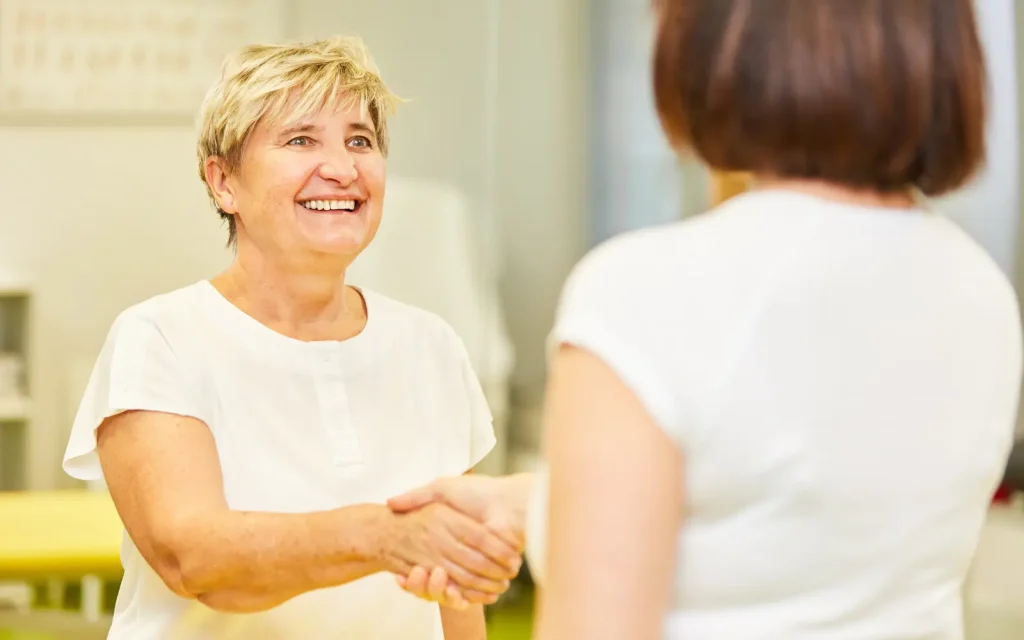 A woman being welcomed into a low-cost therapy session in Los Angeles