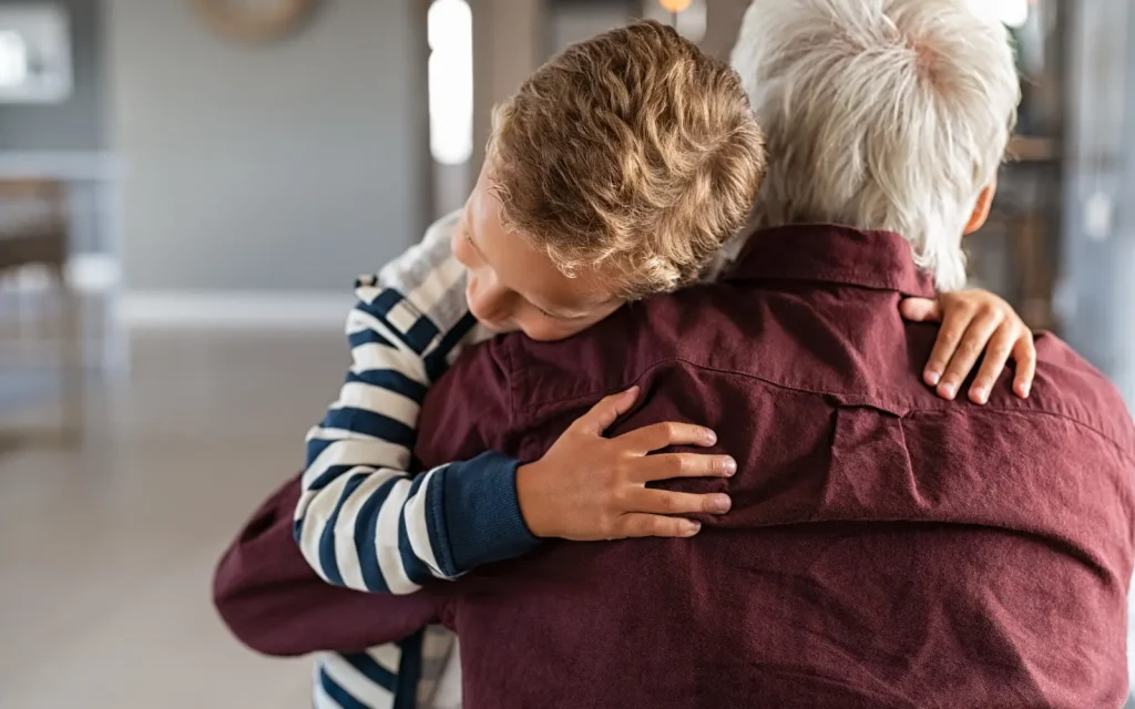 Secure-attachment-through-Los-Angeles-therapy A grandfather embracing his grandson, representing secure attachment