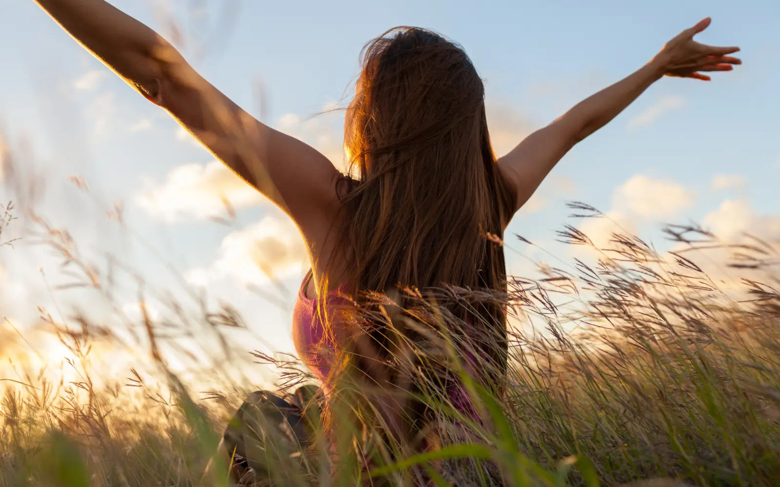 A woman with arms raised over her head representing the freedom from attending neurodiverse therapy in LA