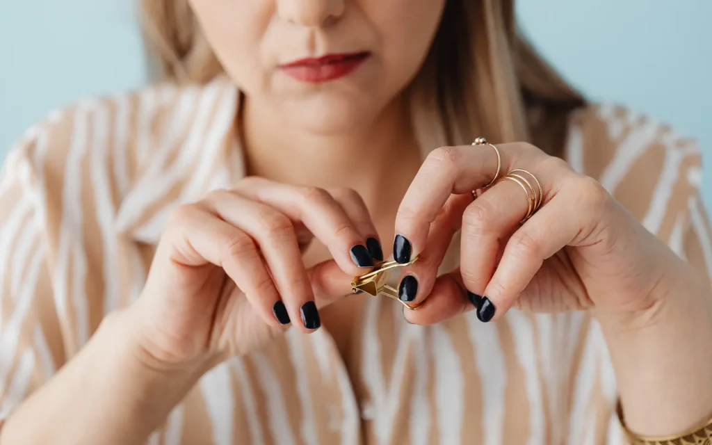 ADHD-fidgeting-in-relationships A woman fidgeting with a paperclip, representing the need for an ADHDer to fidget in order to focus on their partner.