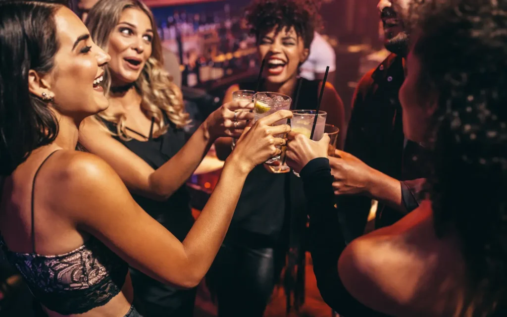 Social-gatherings-at-Christmas-time A Christmas social gathering with four women clinking glasses