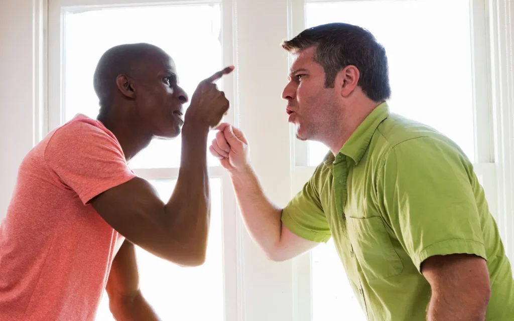 Two men pointing fingers at each other, representing blame and arguments in ADHD relationships