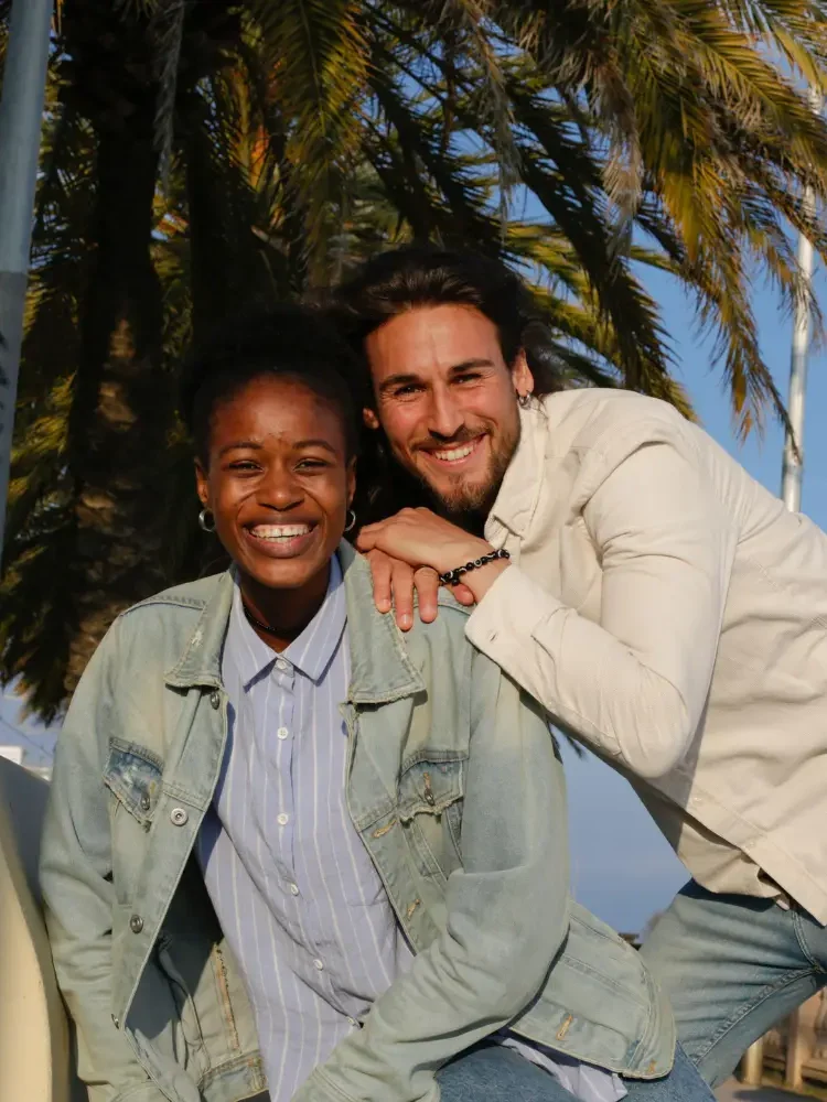 An interracial couple smiling outside in Los Angeles, representing the impact of GGPA's interracial marriage counseling services on couples