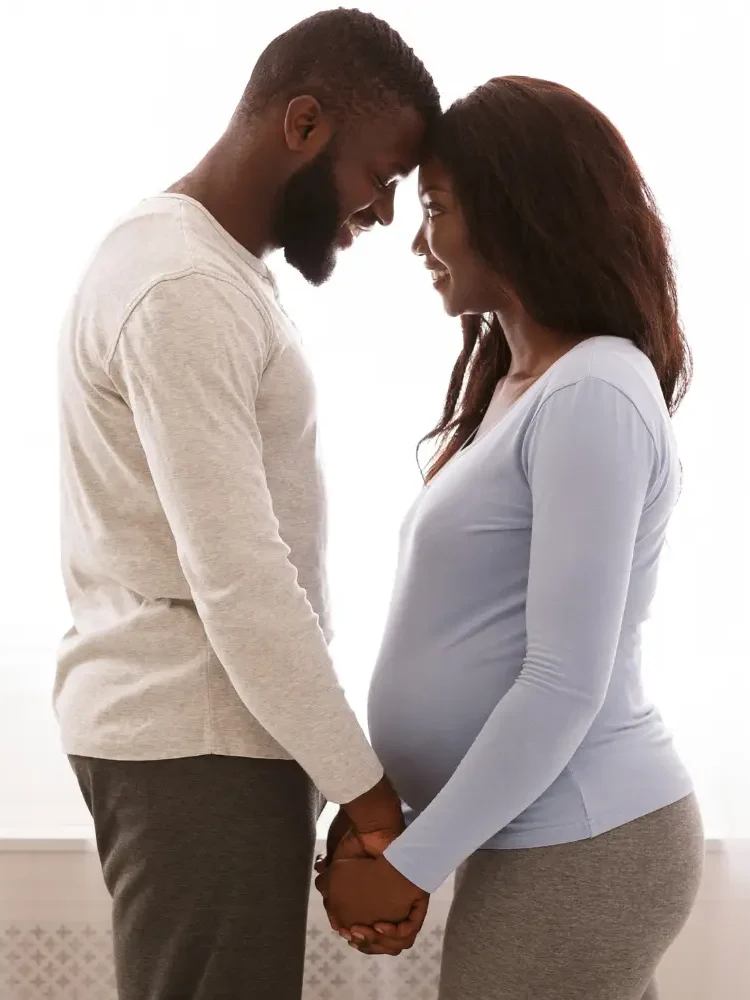 A neurodiverse black couple holding hands and looking into each others' eyes, representing the emotional bonding of neurodiverse couples counseling
