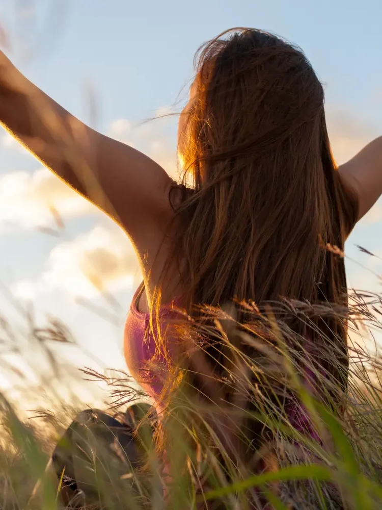 A woman with arms raised over her head representing the freedom from attending neurodiverse therapy in LA
