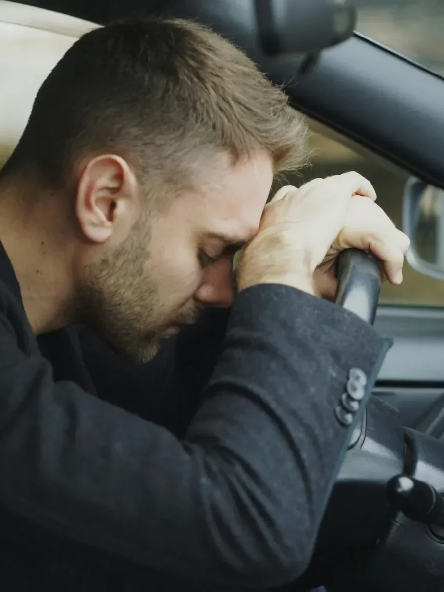 A man in a car during a stressful commute