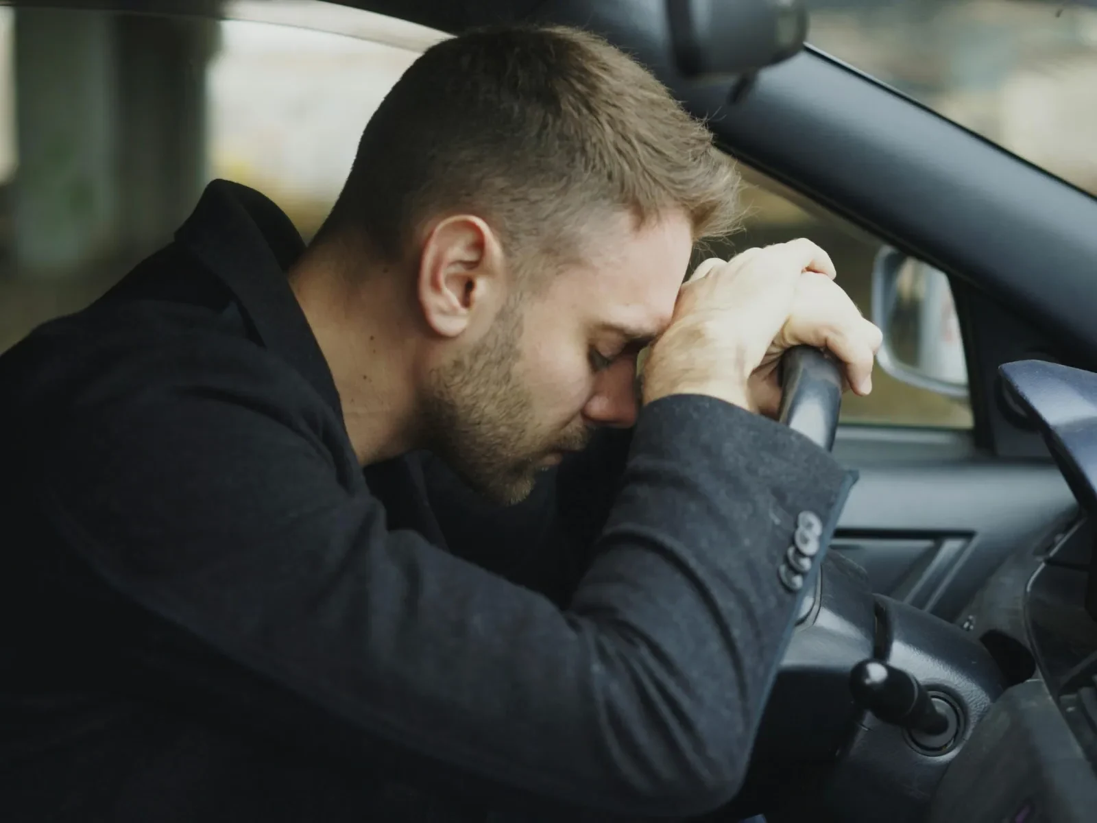 A man in a car during a stressful commute