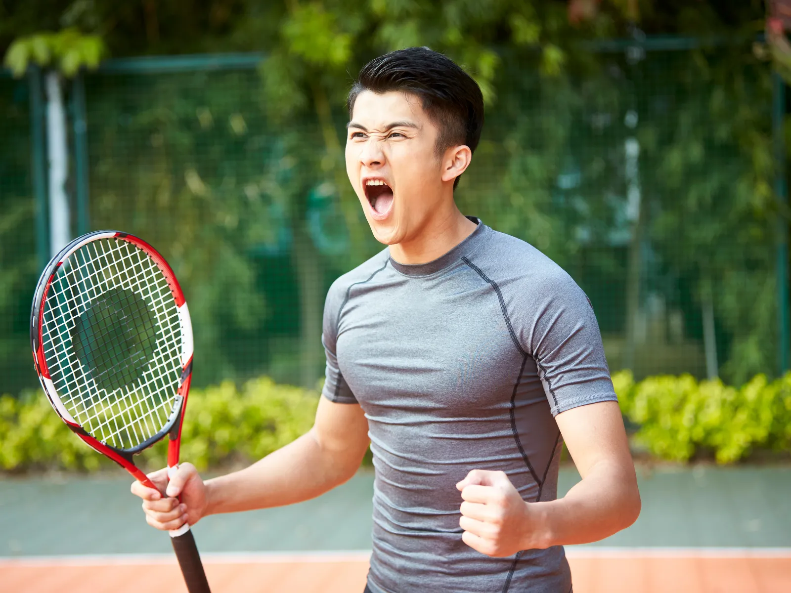 A tennis player celebrating winning their match